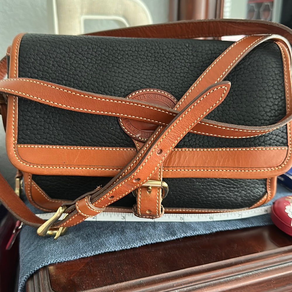 Dooney and Bourke purse crossover strap buckle in front